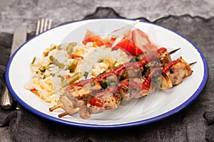 Meat and Cooked white rice mixed with colorful vegetables onion, green beans, tomato