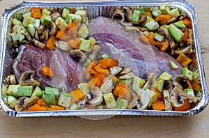 Meat and cut vegetables prepared for frying in their own juice