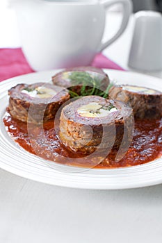 Meat and egg rolls in tomato sauce