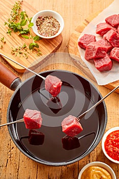 Meat fondue with spice rub and fresh herbs