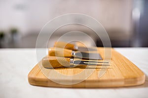 Meat fork and chopper on wooden cutting board