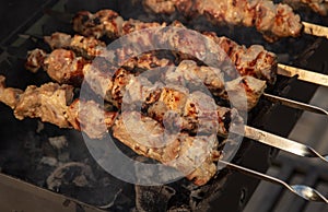 Meat is fried on coals in a brazier.