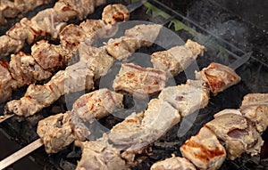 Meat is fried on coals in a brazier.