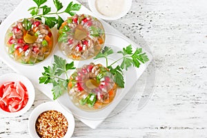 Meat galantine aspic with carrot, pomegranate, peas, parsley on