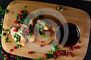 Meat with greens and berries. Wild meat on a wooden board