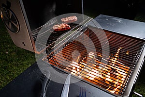 Meat on the grill, cooking in the open air in the evening