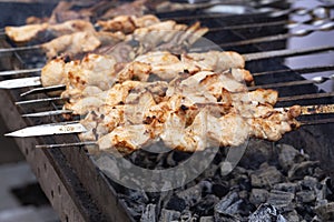 The meat is grilled skewers on a barbecue grill. Delicious bbq kebab grilling on open grill, outdoor kitchen. Food  tasty food roa