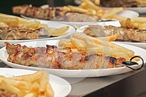 Meat grilled on skewers with fries Greek cuisine. souvlaki