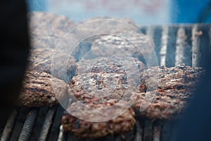 Meat for a hamburger on the grill roasting