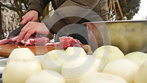 Meat with knife on cutting board.