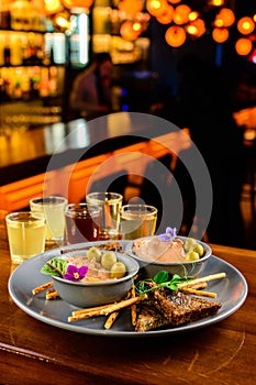 Meat liver pate on toasted bread with fruit seeds on brown table