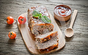 Meat loaf with barbecue sauce on the wooden board