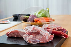 Meat parts with vegetables at background