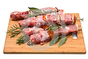 Meat and pepper skewers on a wooden cutting board