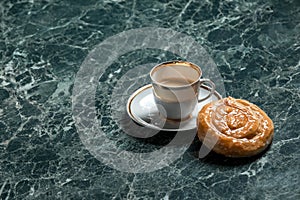 Meat pie with saucer, black coffee on marble background