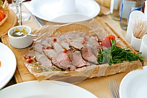 Meat pieces lie on a white plate