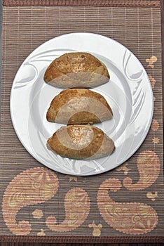 Meat pies on a plate studio shot.