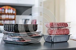 Meat in plastic packaging on a kitchen bench