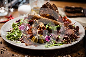 Meat platter for two: Dry-aged beef brisket, duck fillet, beef liver pate, lamb striploin, cranberry jam and grissini