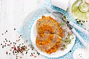 Meat pork chop in bread crumbs garnished with green buckwheat, h