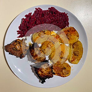 Meat, potatoes with bacon and red beet