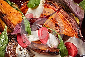 Meat with potatoes and vegetables served at restaurant.