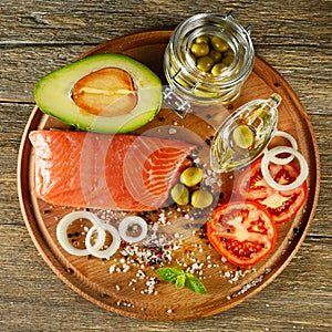 Meat red salmon fish, tomatoes, onion, spices, green olives and