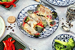 Meat rolls with broccoli and pepper on a plate