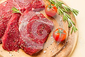 Meat in salt and pepper, rosemary and tomatoes