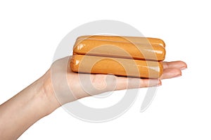Meat sausage for hot dog or barbecue in hand. Isolated on white background. Fast food meal