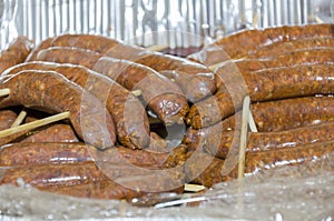 Meat sausages on wooden skewers