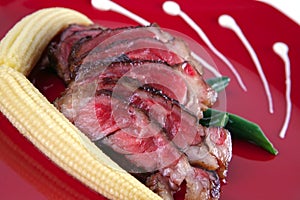 Meat served on red with corns