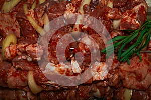 Meat for shish kebab with onions and rosemary.