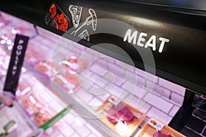 Meat signage at the poultry produce section of supermarket with defocused background