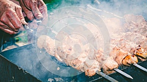 Meat skewer with onion on the skewers on the grill at the stake