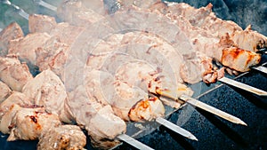 Meat skewer with onion on the skewers on the grill at the stake