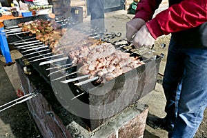 Meat on skewers fried on the grill in the open air
