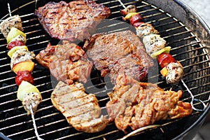 Meat and skewers on the grill