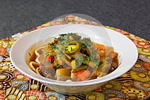 Meat soup with noodles in a plate