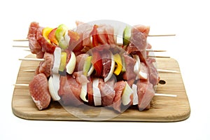 Meat spit on wood plate