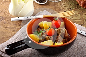 Meat stew with boiled potatoes and tomato