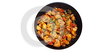 Meat stew with potatoes, pepper, onion and carrot in a frying pan. top view. isolated