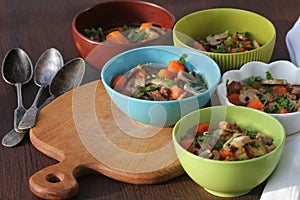 Meat stew with vegetable in bowl on rustic wooden background