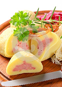 Meat stuffed potato dumplings with shredded cabbage