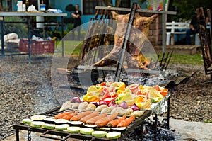 Meat and vegetable exhibition on a barbecue known as Parrilla. Typical barbecue from the south of Latin America photo