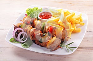 Meat and Vegetable Kebabs Served with French Fries