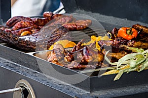 Meat and vegetables are grilled on the kitchen`s large trailer grill, chicken wings and meat ribs