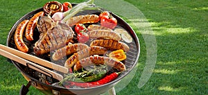 Meat and vegetables grilling on an outdoor BBQ photo