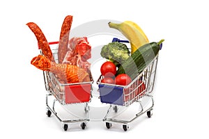 Meat and vegetables in two shopping carts, isolated on white