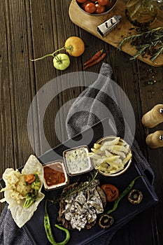 Meat and vegetables on wooden table